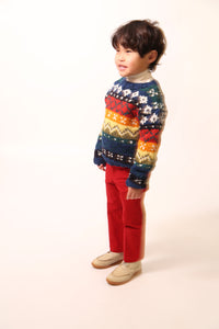 Boy a colorful knit sweater in multicolor Felt Wool Yarn, featuring a unique fair isle pattern. Designed with a classic crew neckline, relaxed fit, and dropped shoulders for all-day comfort and easy layering. Made from 100% Wool, ideal for winter wear. By Tia Cibani.