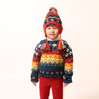 Boy a colorful knit sweater in multicolor Felt Wool Yarn, featuring a unique fair isle pattern. Designed with a classic crew neckline, relaxed fit, and dropped shoulders for all-day comfort and easy layering. Made from 100% Wool, ideal for winter wear. By Tia Cibani.