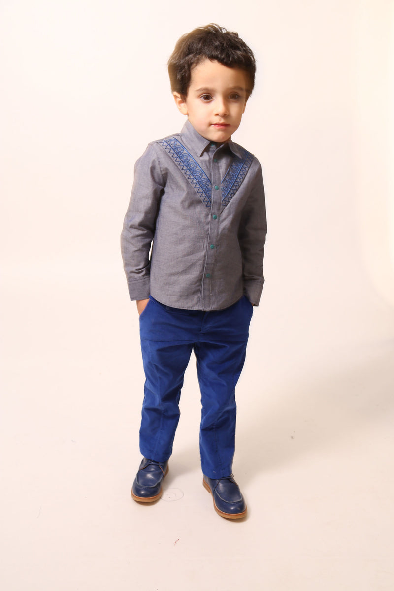 Boy wearing The Conan Embroidered Shirt, featuring high-low scoop hem and two-toned embroidered yoke. Collared with snap closure at center front. Perfect for casual and formal occasions. Colour: Blue,Tia Cibani.