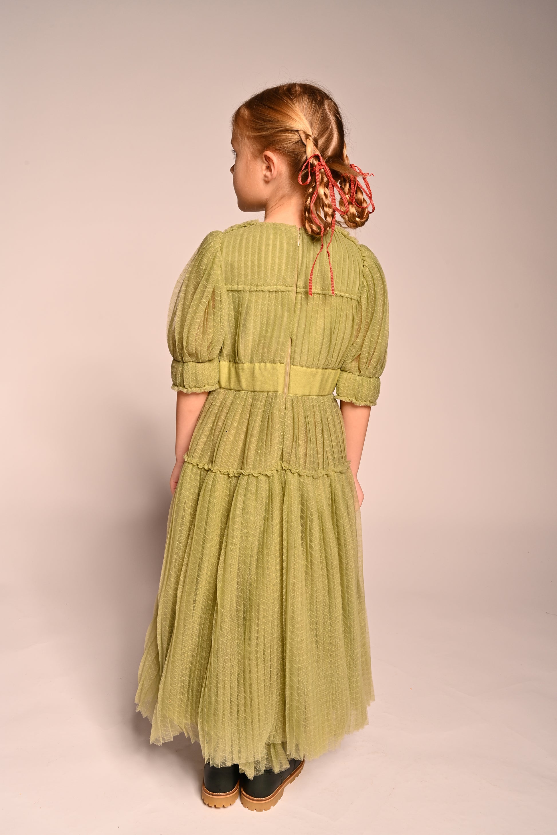 girl wearing green tulle dress with sleeves