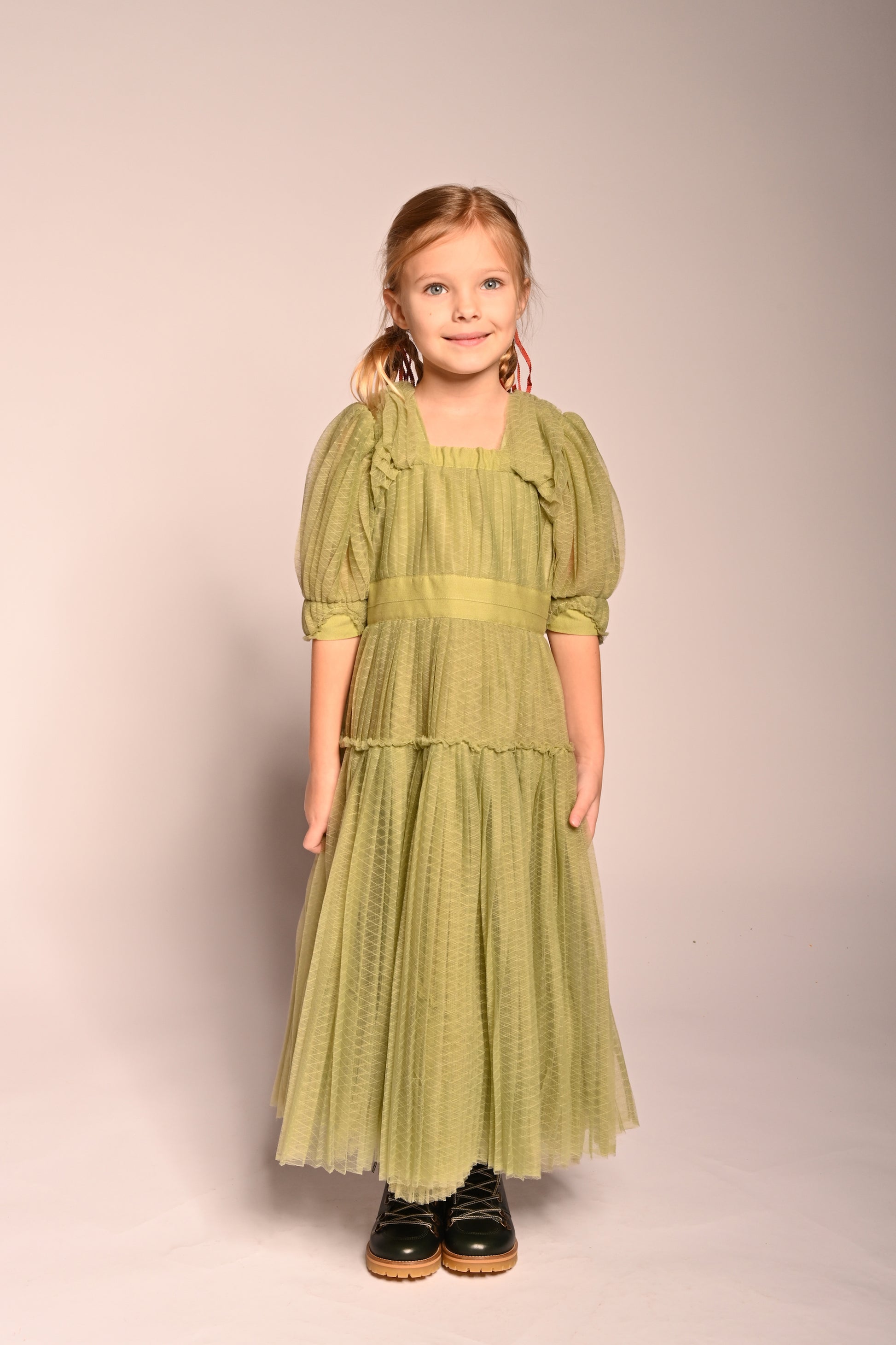 girl wearing green tulle dress with sleeves