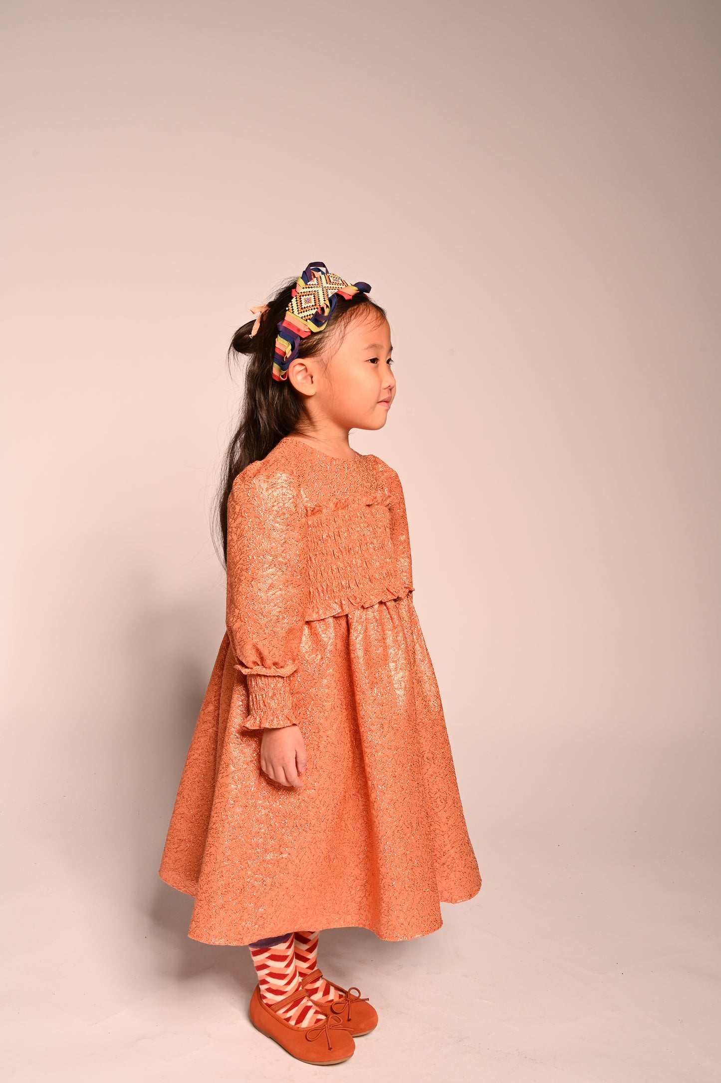 girls orange sparkly smocked dress with long sleeves