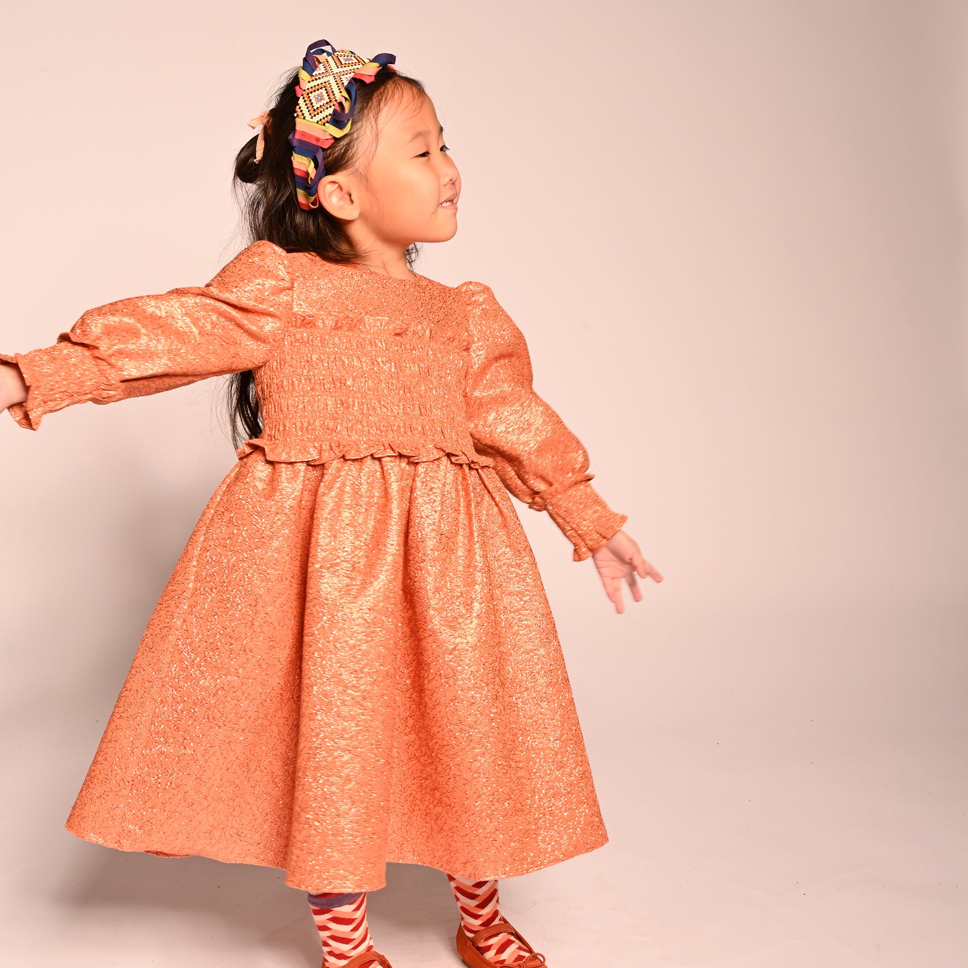 girls orange sparkly smocked dress with long sleeves