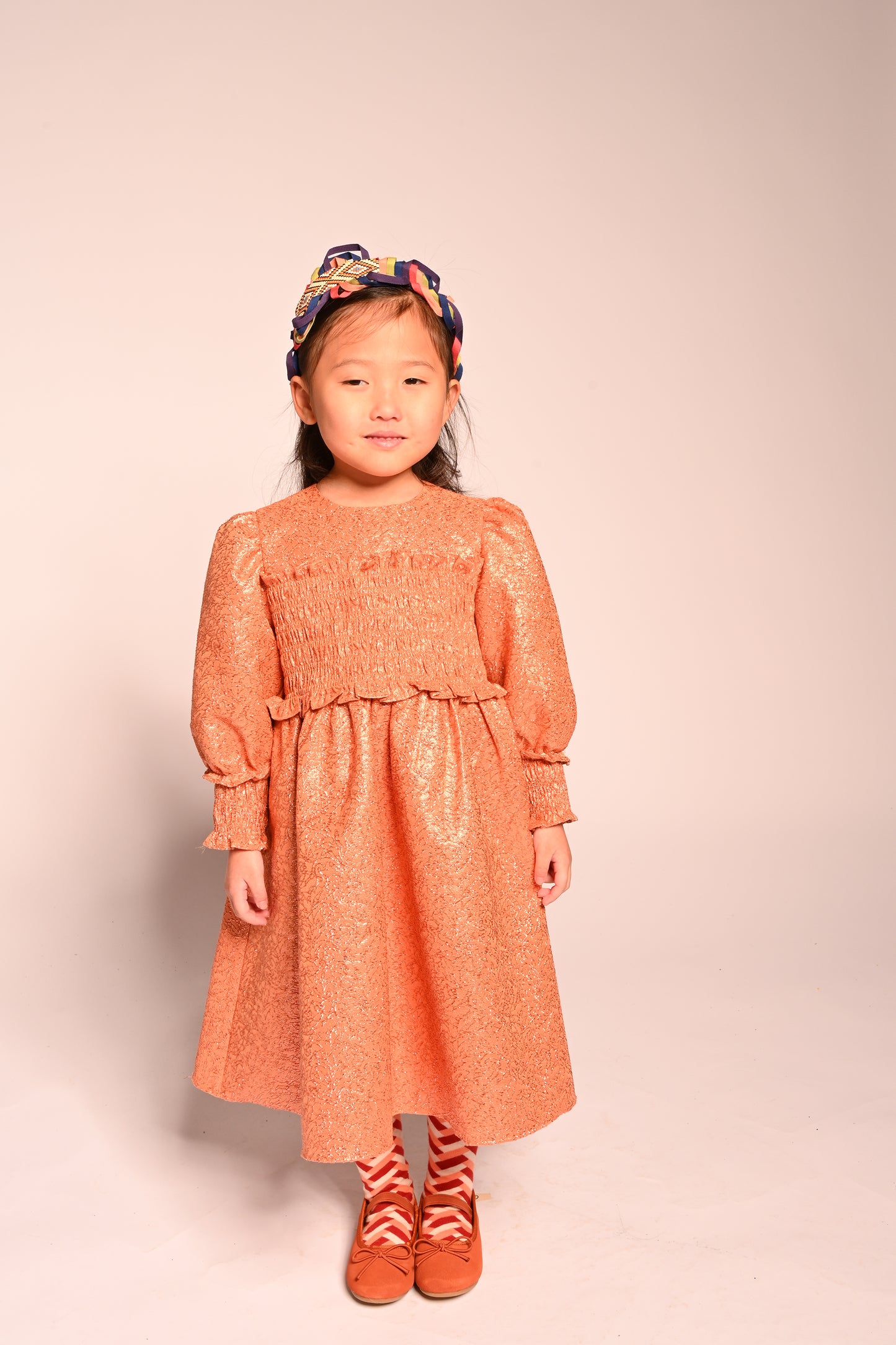 girls orange sparkly smocked dress with long sleeves