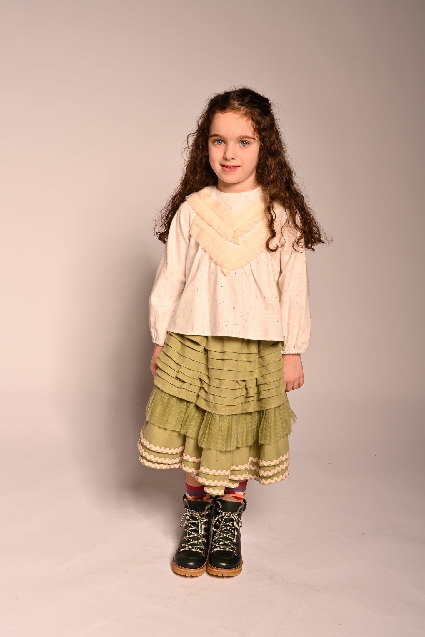 girl wearing green cotton layered with tulle skirt