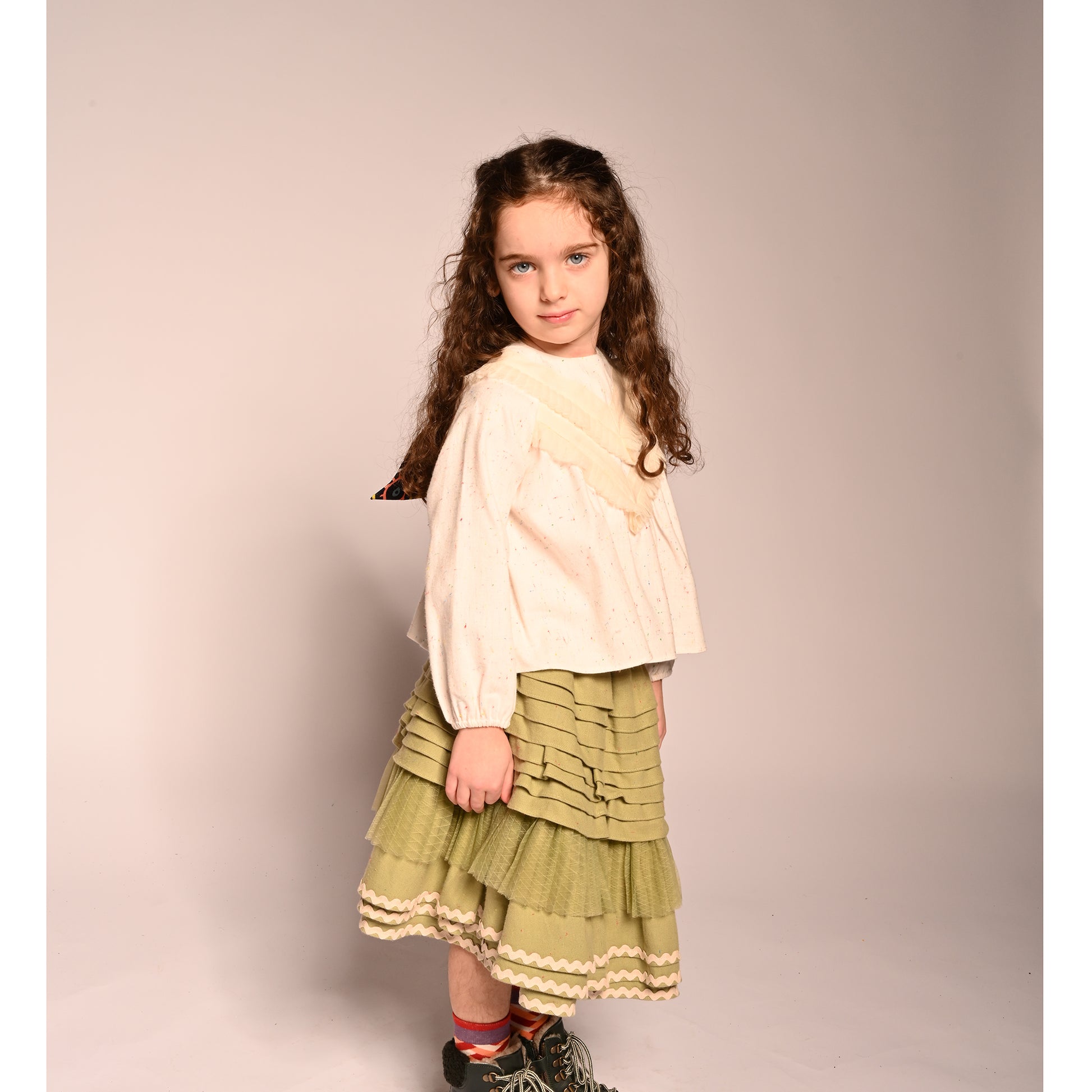 girl wearing green cotton layered with tulle skirt