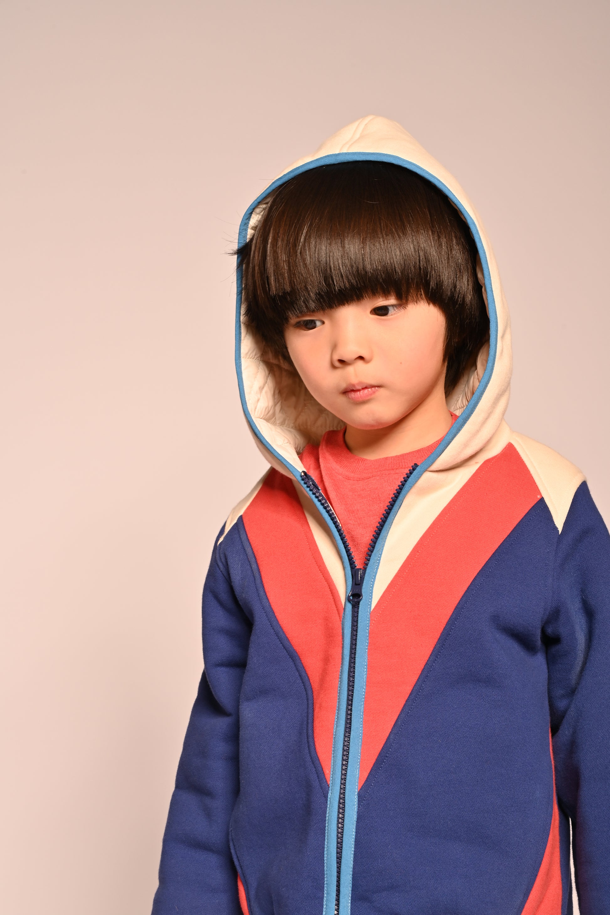 boy wearing patchwork red white and blue cotton fleece zip up hoodie by TiA CiBANi