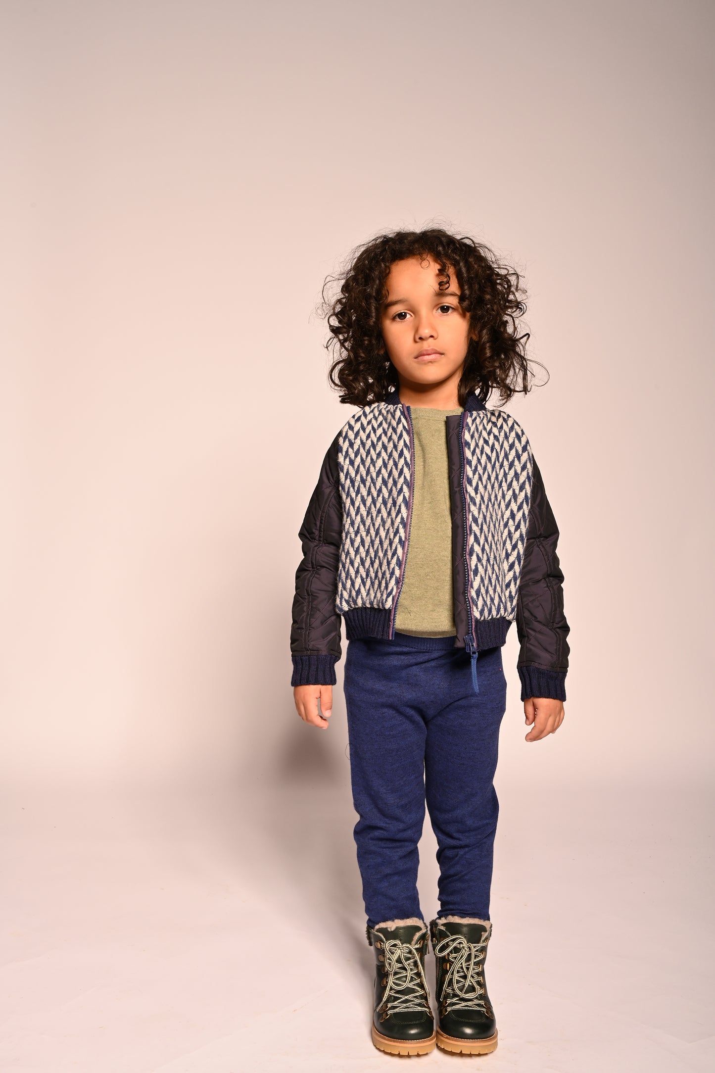 boy wearing blue and white patchwork taffeta and wool bomber jacket