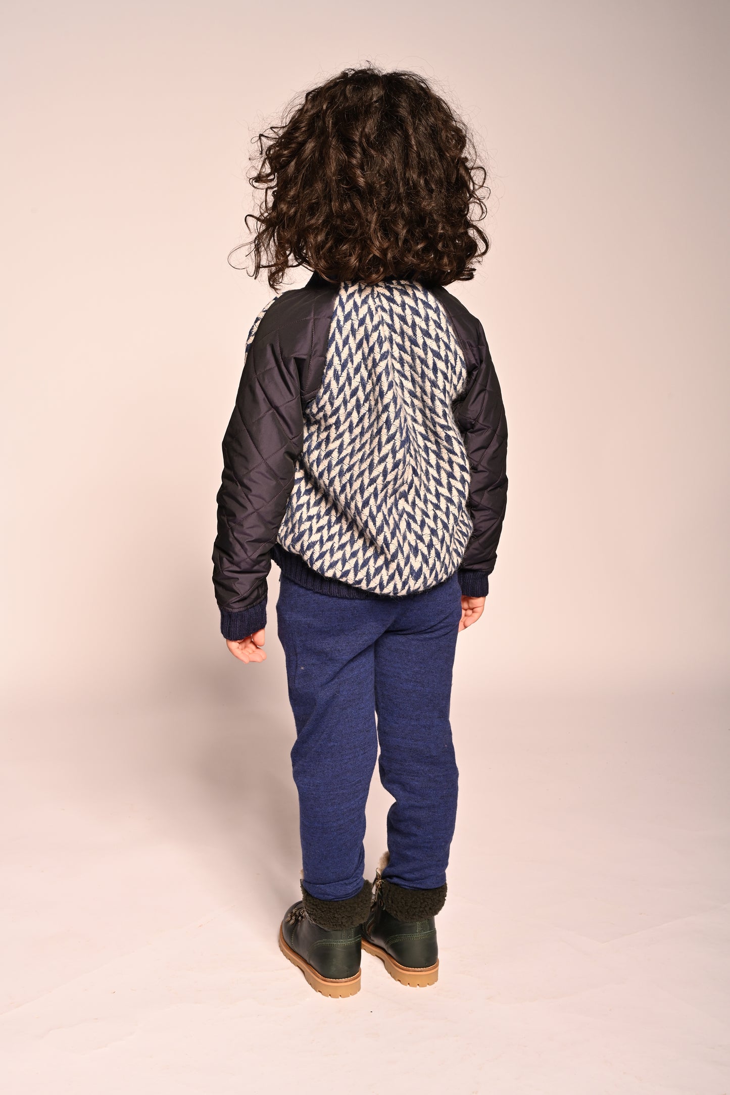 boy wearing blue and white patchwork taffeta and wool bomber jacket