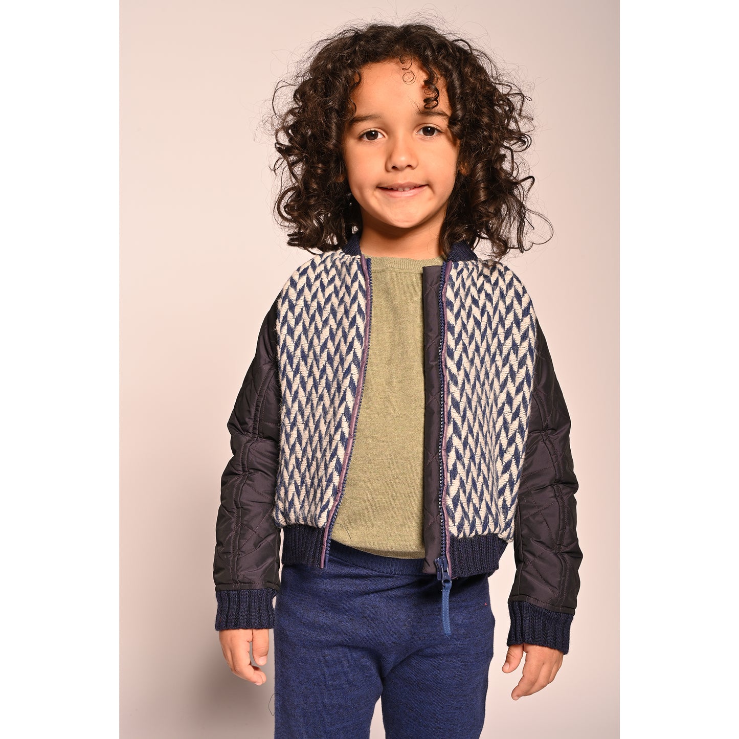 boy wearing blue and white patchwork taffeta and wool bomber jacket