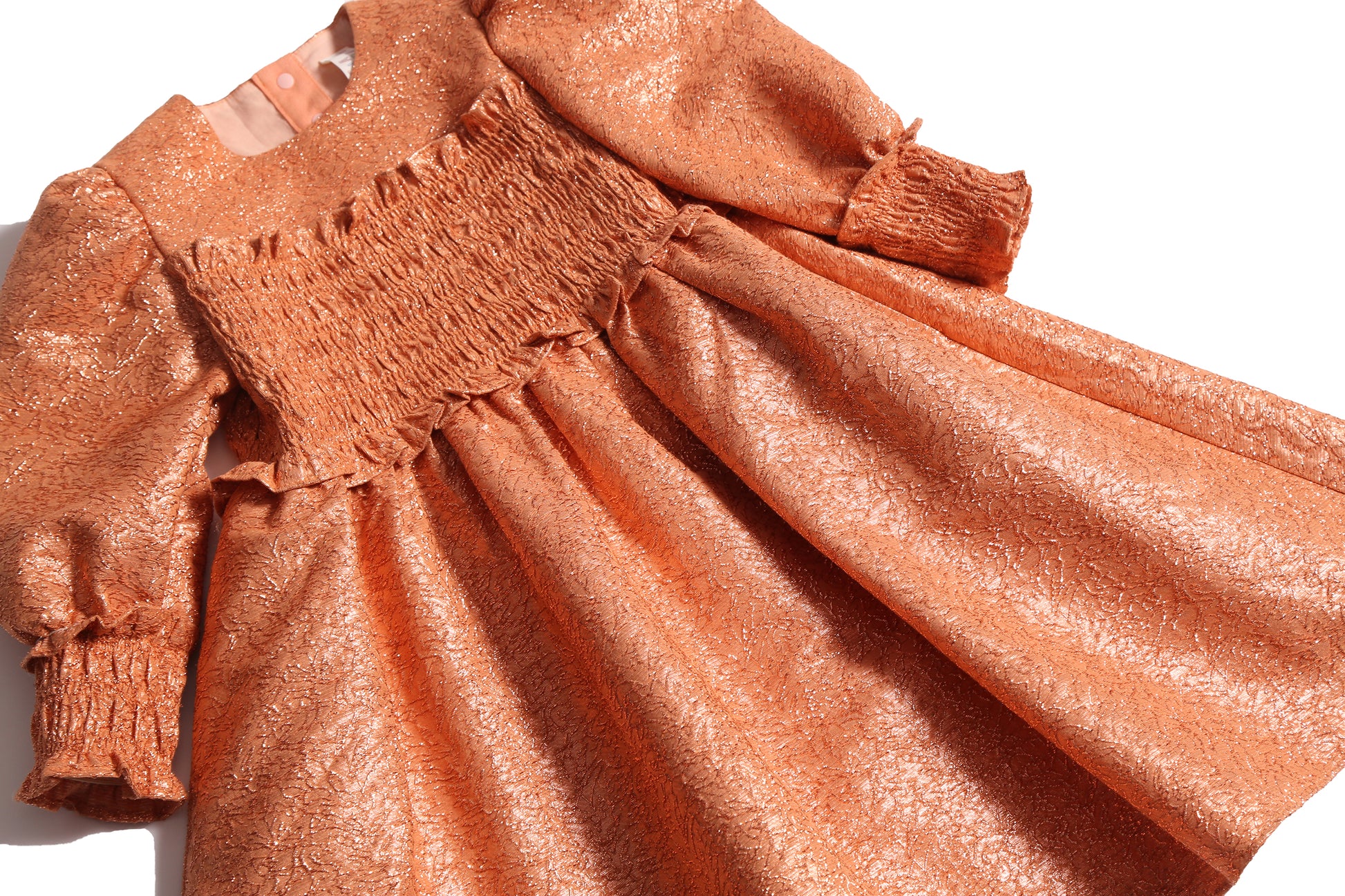 girls orange sparkly smocked dress with long sleeves