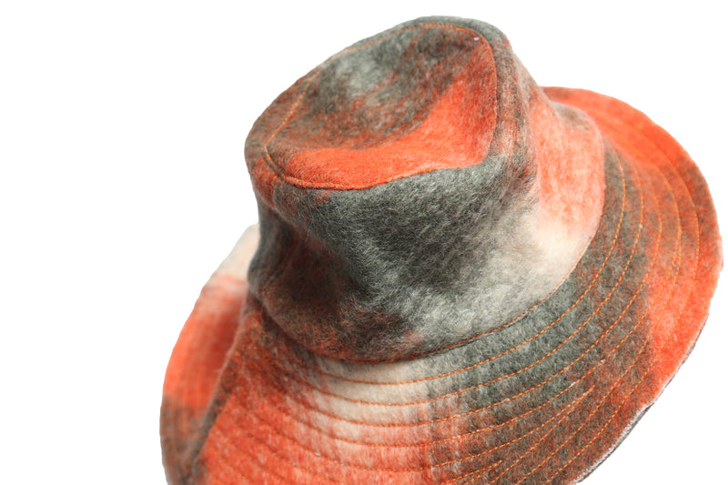 Stylish bucket hat in timeless Celtic Shadow Plaid pattern, adding classic charm to any outfit. Topstitch thread detailing along the brim for a nice finishing touch. Wide brim at the back for excellent protection and contemporary look. Mainly orange, Tia Cibani.