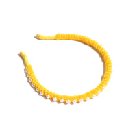 Vibrant chenille headband wrapped in playful pipe cleaners, lined with pearls at the crown, adding charm to any hairstyle. Colour: yellow, Tia Cibani.