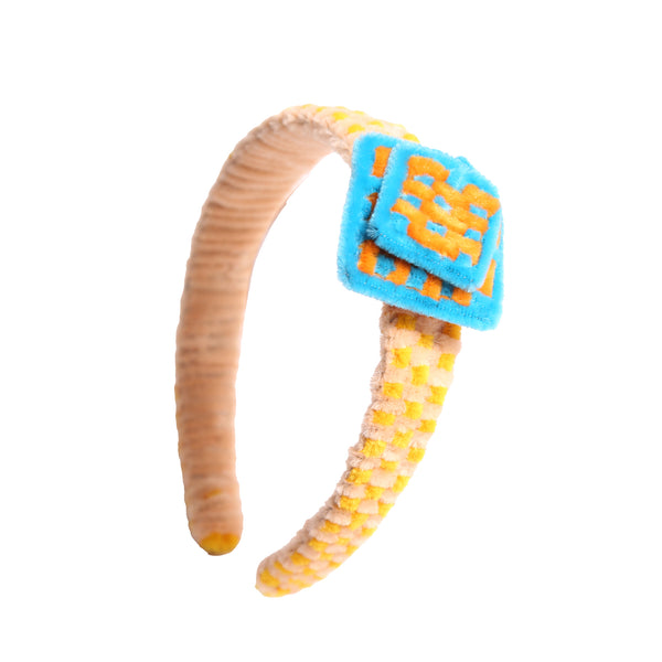 Headband wrapped and weaved in artistic two-tone effect using vibrant pipe cleaners. Topped with layers arranged asymmetrically in charming squares. Adds pop of color and personality to any hairstyle. Colours: Yellow, Sky Blue, Orange,Tia Cibani.