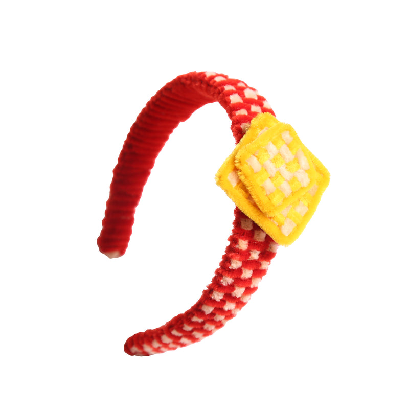 Headband wrapped and weaved in artistic two-tone effect using vibrant pipe cleaners. Topped with layers arranged asymmetrically in charming squares. Adds pop of color and personality to any hairstyle. Colours: Yellow, Red, Tia Cibani.