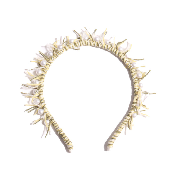 Headband wrapped in multi-colored, predominantly yellow mustard, wool yarn, with fringing at the crown and hand-stitched pearls at the top, by Tia Cibani.