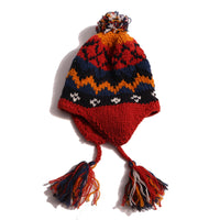 Cozy and playful toque style hat with multi-color tassels and pom pom at the top for a fun pop of color. Features ear flaps for extra warmth, hand-knitted with charming colorful fair isle pattern. Made of 100% Wool. Wear with this season's fair isle sweaters or outerwear pieces. Blue and rouge, Tia Cibani.