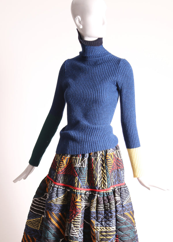 Slim fit, ribbed Felted Wool Yarn turtleneck with multi-color contrasting patchwork at sleeves. Bold spin on classic basic for mom. High-quality knit staple for fall and winter seasons. Wool, Blue. By Tia Cibani.