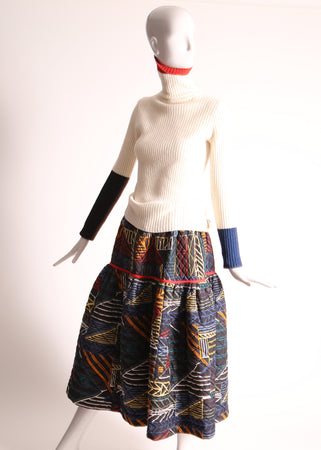 Rainbow printed voluminous skirt for mom, tufted in diamond harlequin pattern and padded for cozy luxury. Tealength with contrast binding tape detail on flare volume skirt. Pull-on elastic waistband, in-seam pockets, lined in 100% soft jersey cotton for comfort and function. Pair with Women's Patchwork Ribbed Turtlenecks. Tia Cibani.