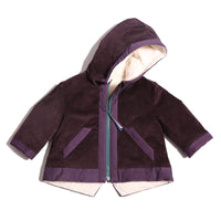 Baby coat made from Prune Breton Tarp Velvet, featuring down filling, an attached hood, slanted ribbon welt pockets, a V cut-out vent at the back hemline, and a center front zipper with a multi-colored ribbon pully for added flair. Lined with soft jersey at the body and nylon lining in the sleeves, by Tia Cibani.