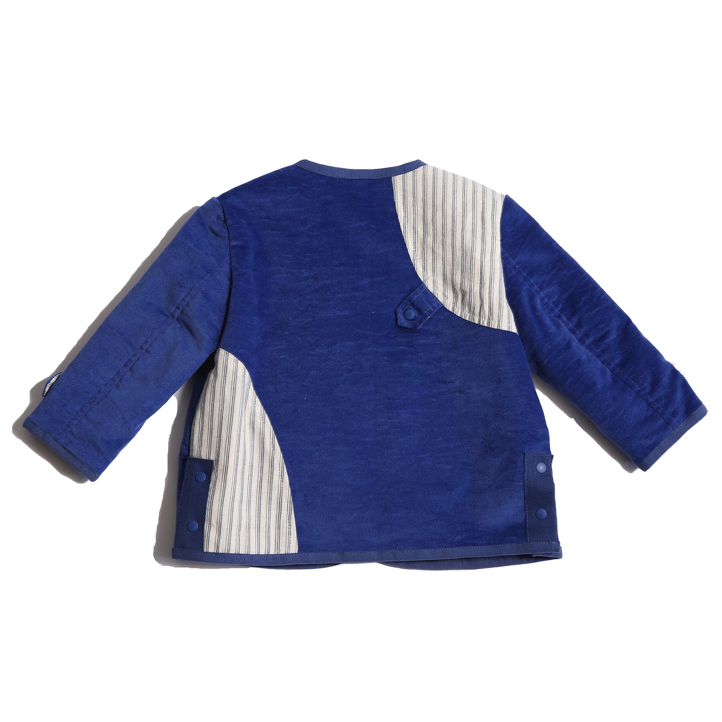 Padded patchwork jacket in Blue and White, featuring an easy relaxed fit for comfort and layering. Includes a snap placket closure at the front flap for a touch of military-inspired flair. Made from structured velvet and soft cotton striped shirting, fully faced for comfort. Complete with patch pockets, interior ribbon tie, and binding tape trim throughout, ideal for all-day wear, by Tia Cibani. Back View.