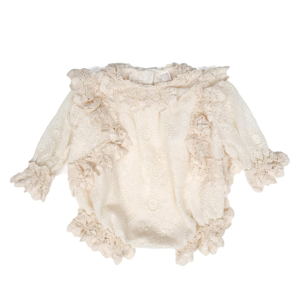 Delicate lace-trimmed onesie in Opal color, featuring lace trim at crew neckline, armholes, sleeve cuffs, and leg openings. Designed for easy dressing with snap closures at the back and crotch, and comfortable elastic at leg and sleeve openings for all-day comfort. Made from embroidered lace with a voluminous and relaxed fit, perfect for your little one, by Tia Cibani.