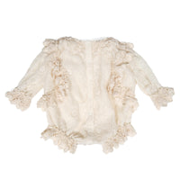 Delicate lace-trimmed onesie in Opal color, featuring lace trim at crew neckline, armholes, sleeve cuffs, and leg openings. Designed for easy dressing with snap closures at the back and crotch, and comfortable elastic at leg and sleeve openings for all-day comfort. Made from embroidered lace with a voluminous and relaxed fit, perfect for your little one, by Tia Cibani. Back View,