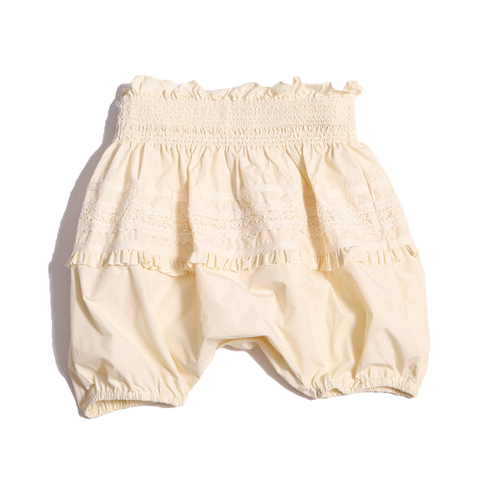 Voluminous baby bloomers in luxurious white Taffeta with delicate lace applique at the hips and hidden elastic at leg openings. Waterfall gathered construction for extra sweetness, Tia Cibani.