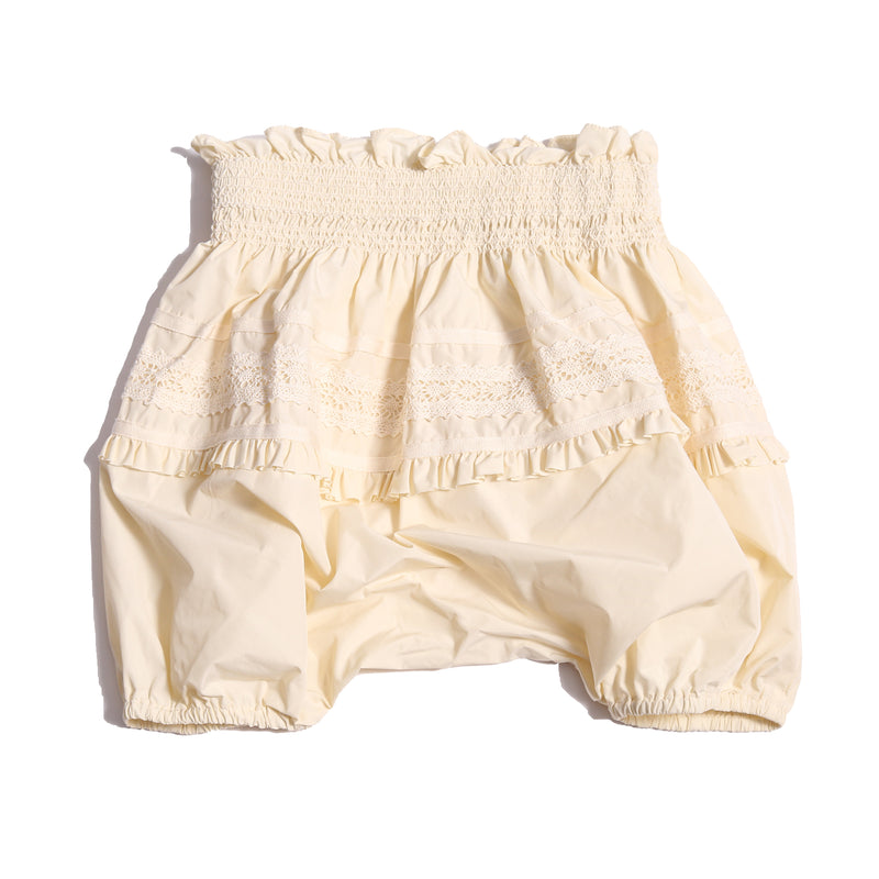 Voluminous baby bloomers in luxurious white Taffeta with delicate lace applique at the hips and hidden elastic at leg openings. Waterfall gathered construction for extra sweetness, Tia Cibani.