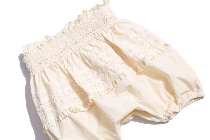 Voluminous baby bloomers in luxurious white Taffeta with delicate lace applique at the hips and hidden elastic at leg openings. Waterfall gathered construction for extra sweetness, Tia Cibani.