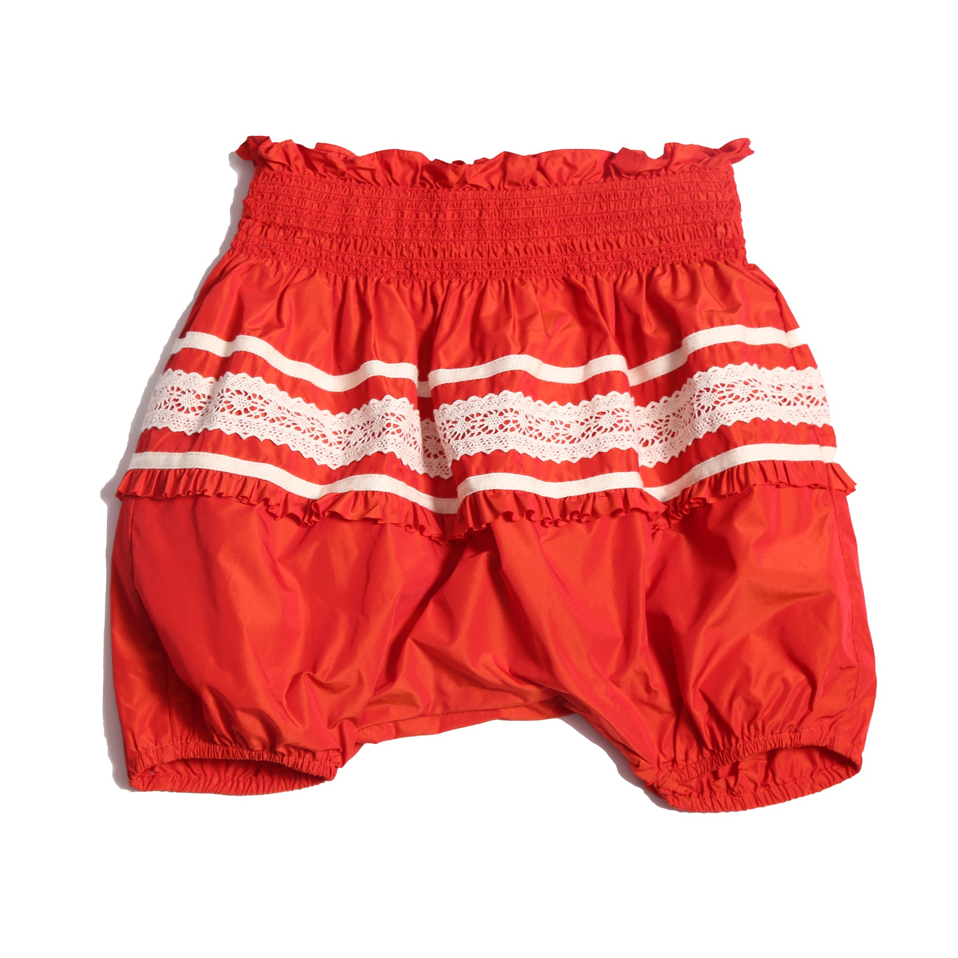 Voluminous baby bloomers in luxurious rouge and white Taffeta with delicate lace applique at the hips and hidden elastic at leg openings. Waterfall gathered construction for extra sweetness, Tia Cibani.