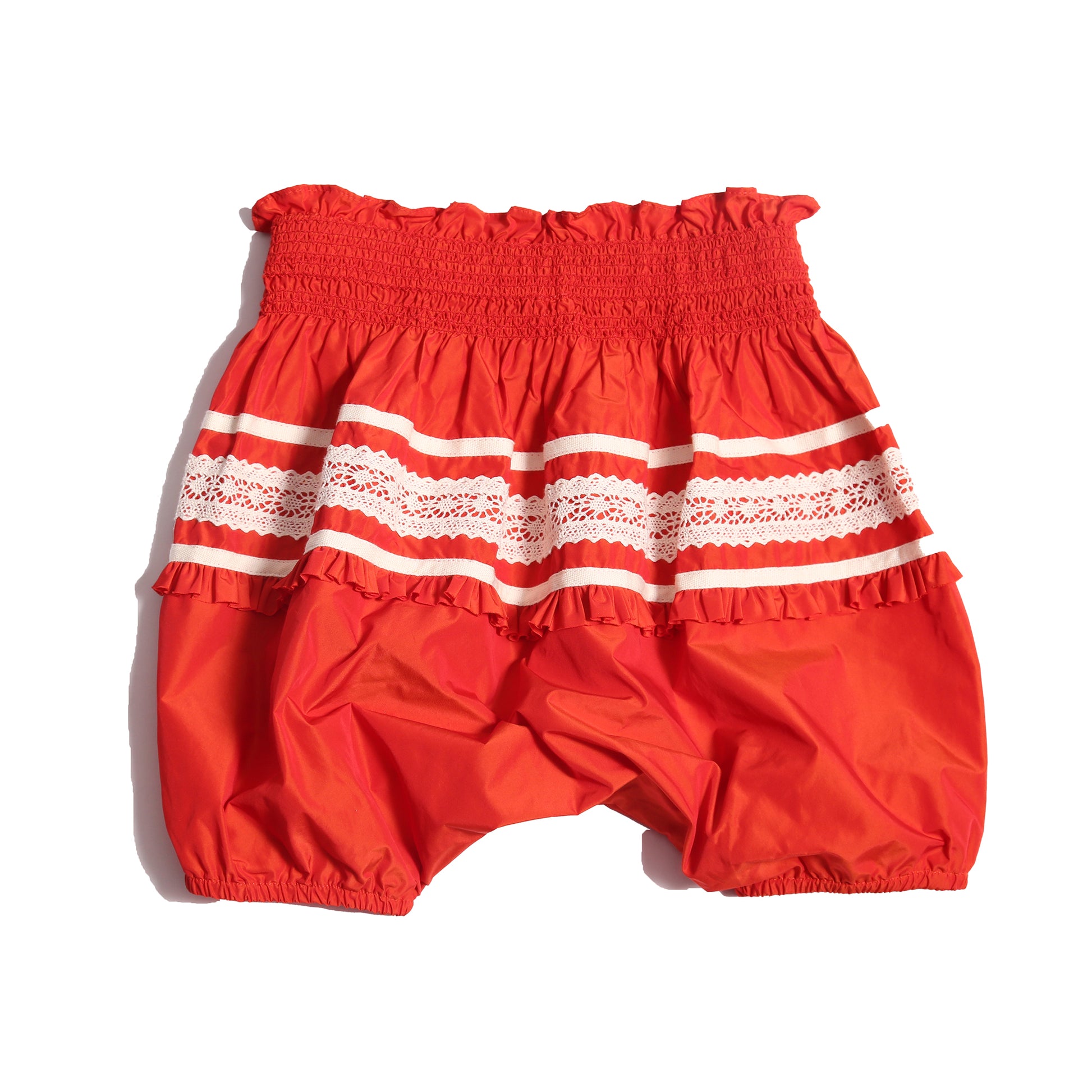 Voluminous baby bloomers in luxurious rouge and white Taffeta with delicate lace applique at the hips and hidden elastic at leg openings. Waterfall gathered construction for extra sweetness, Tia Cibani.