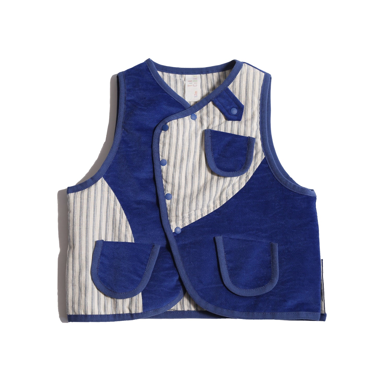  Padded patchwork vest in Blue and White, featuring an easy box fit for layering and comfort. Includes binding tape at all edges, patch pockets for storage, and a snap button closure at the center front flap. Made from structured velvet and soft cotton striped shirting, fully faced for added comfort. Versatile and stylish, perfect for any occasion, by Tia Cibani.