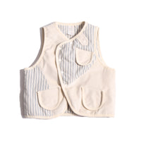  Padded patchwork vest in White, featuring an easy box fit for layering and comfort. Includes binding tape at all edges, patch pockets for storage, and a snap button closure at the center front flap. Made from structured velvet and soft cotton striped shirting, fully faced for added comfort. Versatile and stylish, perfect for any occasion, by Tia Cibani.