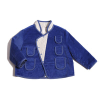 Padded patchwork jacket for boys with easy relaxed fit for comfort and layering. Double snap placket closure adds military-inspired flair. Fully faced with soft cotton striped shirting and patchworked with structured velvet on the outside. Features multiple patch pockets for treasures, binding tape trim throughout, and stand-up collar. Pair with Breton Slim Fit Trousers for refined look. Blue and white, Tia Cibani.