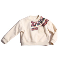 Sueded Fleece jersey pullover for boys, featuring long sleeves, tonal jersey ribbing at neckline, hem, and cuffs for comfort and style. Colorful asymmetric screen print at shoulder. Taffeta pocket detail at left chest for treasures. Dropped shoulders, relaxed fit. White, Tia Cibani.