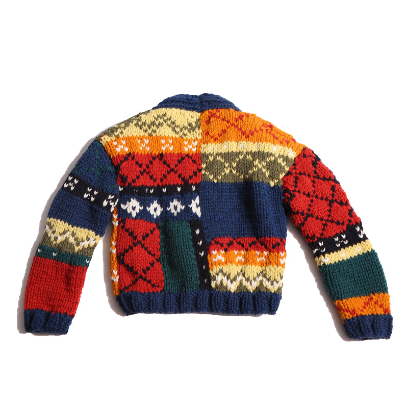  Colorful fair isle cardigan in a patchwork design, blending various fair isle patterns with solid colors of Felt Wool Yarn. Features a relaxed fit with faux horn buttons at the center front, ideal for layering over basic knits. Made from 100% Wool. Color: Multicolor. By Tia Cibani.