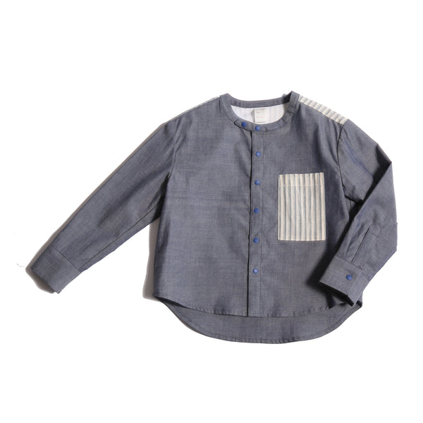 This season's Finn Classic Snap Shirt in patchwork Chambray Cotton Shirting and lightweight striped cotton shirting at pocket and yoke. Snaps at center front and cuffs, high-low scoop hem, long sleeves. Colour: Blue, Tia Cibani.