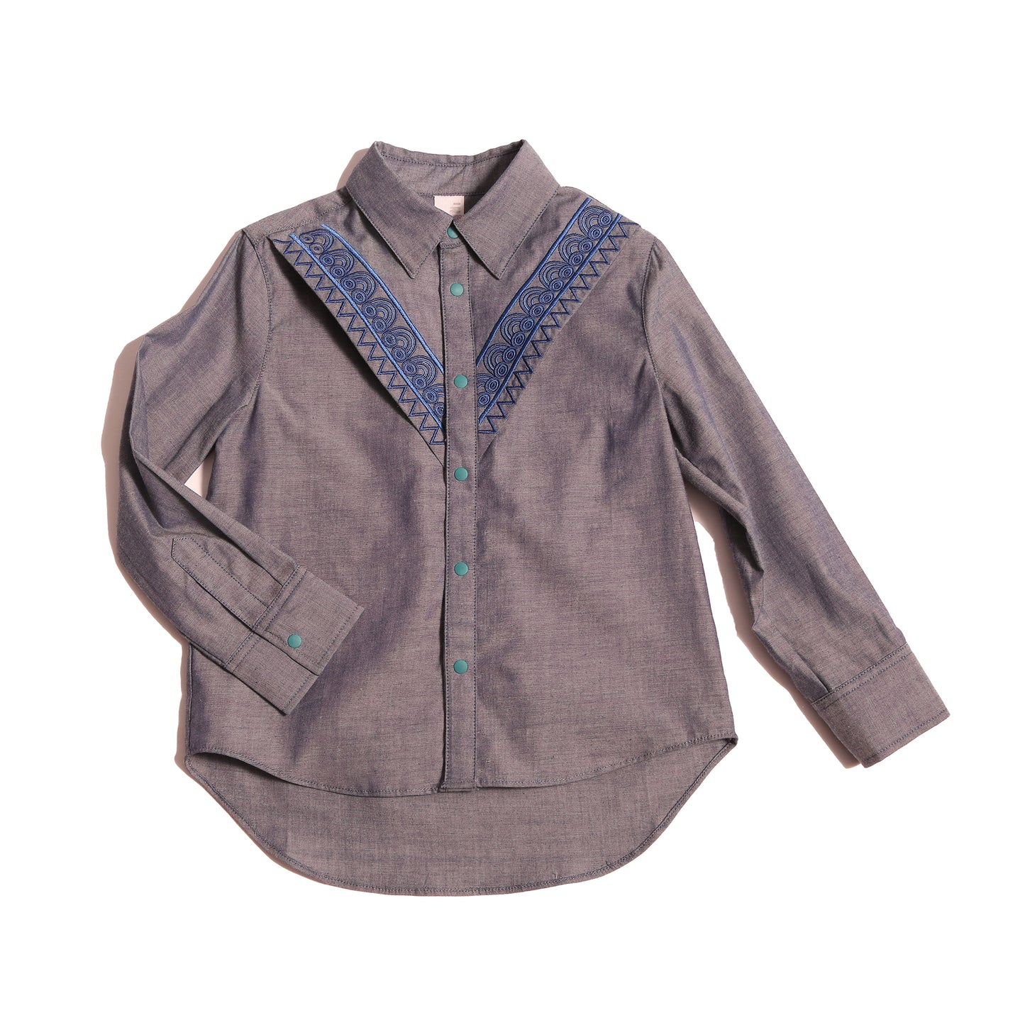 The Conan Embroidered Shirt, featuring high-low scoop hem and two-toned embroidered yoke. Collared with snap closure at center front. Perfect for casual and formal occasions. Colour: Blue,Tia Cibani.