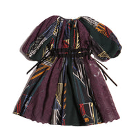 Patchworked frock for girls with signature print, embroidered lace, and liquid canvas fabric. Soft cotton lining, layered Argyle Tulle for volume, cinched sleeves, scoop neckline, and adjustable ribbon waist detail. Perfect for special occasions. Dark Rainbow,Tia Cibani.