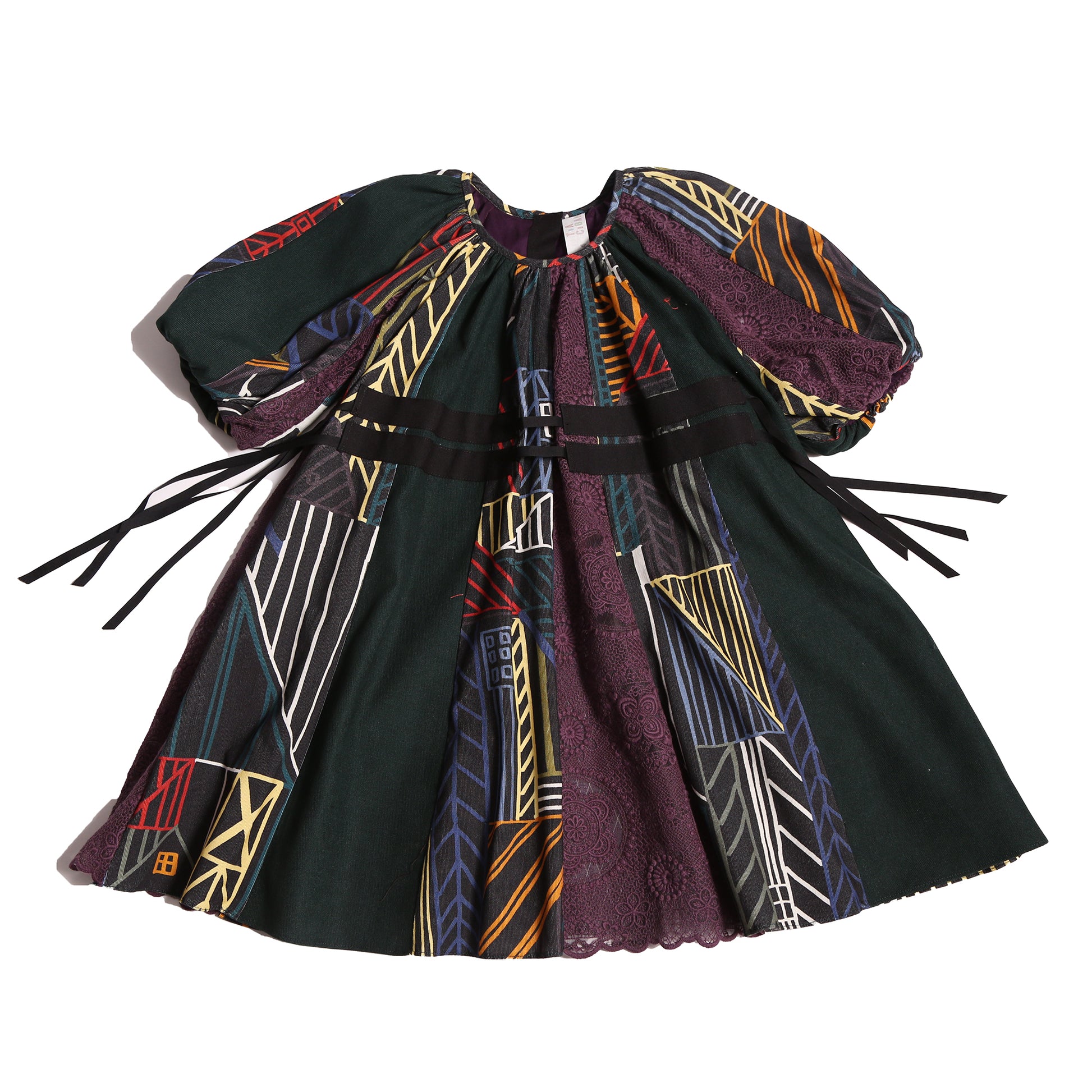 Patchworked frock for girls with signature print, embroidered lace, and liquid canvas fabric. Soft cotton lining, layered Argyle Tulle for volume, cinched sleeves, scoop neckline, and adjustable ribbon waist detail. Perfect for special occasions. Dark Rainbow,Tia Cibani.