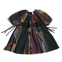 Patchworked frock for girls with signature print, embroidered lace, and liquid canvas fabric. Soft cotton lining, layered Argyle Tulle for volume, cinched sleeves, scoop neckline, and adjustable ribbon waist detail. Perfect for special occasions. Dark Rainbow,Tia Cibani.