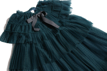 Maxi dress with tiers of tulle, a capelet style top, ribbon tie at the neck for easy adjusting, and matching ribbon belt to tie into a bow at the waist. Finished with raw edges. Perfect party dress. Celtic, Tia Cibani.
