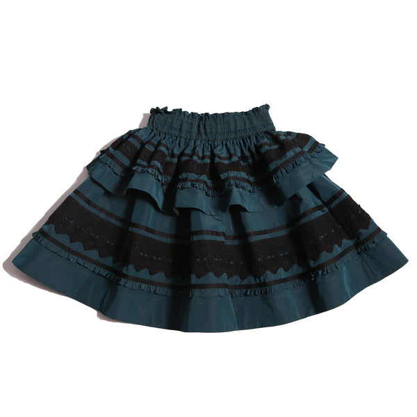 Tealength two-tiered taffeta skirt with elasticized smocking at the waistband, embroidered lace trim, and ribbon at each tier. Unlined for lightweight feel. Colour: Celtic,Tia Cibani.