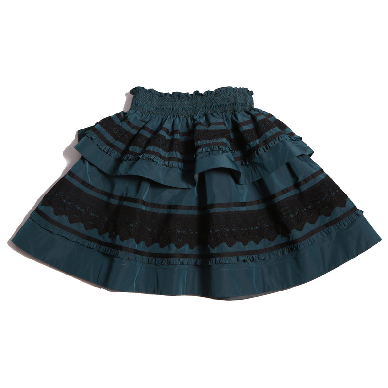 Tealength two-tiered taffeta skirt with elasticized smocking at the waistband, embroidered lace trim, and ribbon at each tier. Unlined for lightweight feel. Colour: Celtic,Tia Cibani.