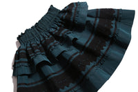 Tealength two-tiered taffeta skirt with elasticized smocking at the waistband, embroidered lace trim, and ribbon at each tier. Unlined for lightweight feel. Colour: Celtic, Tia Cibani.