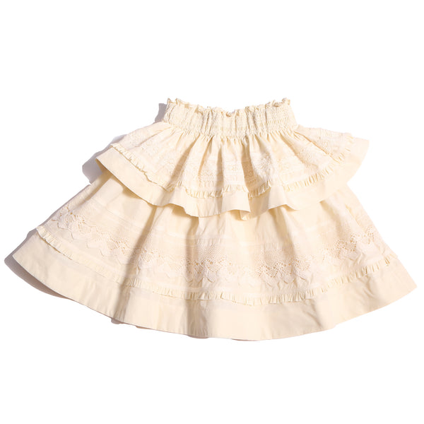 Tealength two-tiered taffeta skirt with elasticized smocking at the waistband, embroidered lace trim, and ribbon at each tier. Unlined for lightweight feel. Colour: Opal, Tia Cibani.
