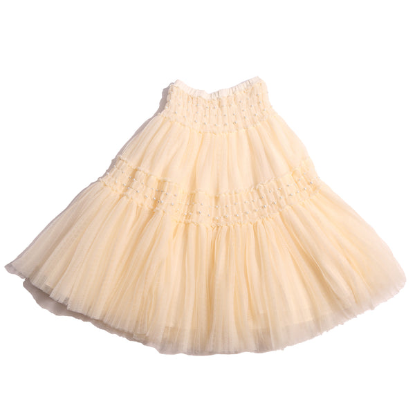 Maxi length Argyle Tulle skirt with pearls and elasticized tonal smocking panels at waist and hips. Deep pleats for volume, lined in tonal cotton lining with elastic pull-on waistband. Two layers of tulle for a princess-like feel. Colour: Opal, Tia Cibani.