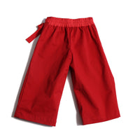 Deep pleated trousers designed for comfort and style, featuring an easy elastic waistband with ribbon tie detailing for a charming bow at the side waist. Crafted in comfortable Chamois Cotton Twill, unlined for lightweight feel, perfect for everyday wear. Complete with slant pockets at side seams. Pair with Gwenn Collared Topper for a complete look. Rouge, Tia Cibani.