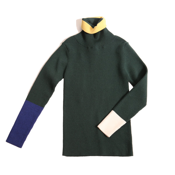 Slim fit, all-over ribbed turtleneck featuring colorblocking and contrast patchwork detailing at sleeves and neckline in this season's fine knit yarn colors. Ideal for wearing alone or as a layering piece in chilly seasons. Celtic, Tia Cibani.